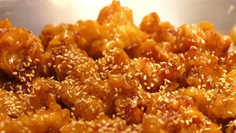 Extreme Close-up of Crispy Sesame Chicken in Sticky Sweet Glaze Video stock 343027495