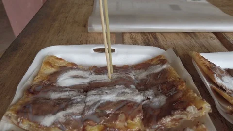 Extreme close up of delicious freid pancake whit chocolate, coco milk Stock Footage 112160155