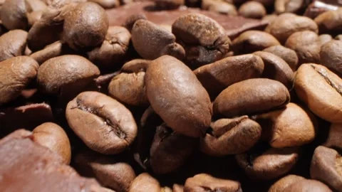 Extreme close-up of detailed coffee beans and bittersweet chocolate chunks with Stock Footage 195091899