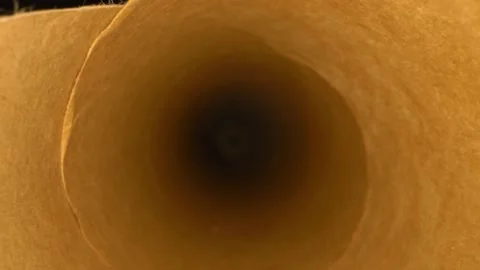 Extreme close-up, detailed. inside view of wrapping paper scroll Stock Footage 143695314