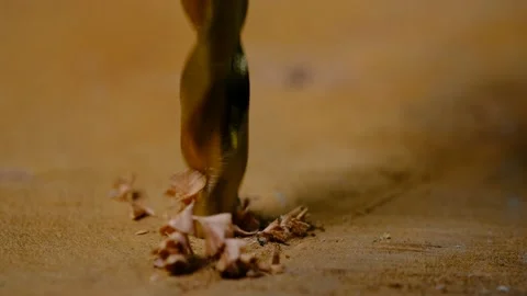 Extreme close up of a drill bit drilling hole in a board Stock Footage 138947968