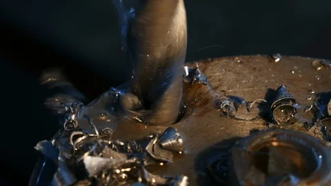 Extreme close-up of drilling machining process in metal part on a lathe, water Stock Footage 117431167