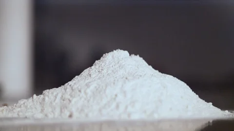 Extreme close up of egg falling into flour Stock Footage 86465849