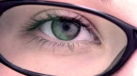 Extreme close up of an eye through the glasses. Stock Footage 12402931