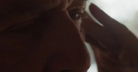 Extreme close-up of the face of an elderly man suffering from a headache Stock Footage 211686021
