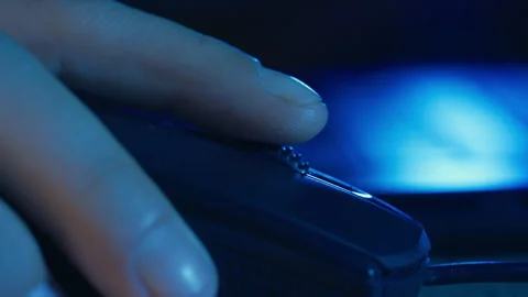 Extreme Close-Up of Finger Clicking Computer Mouse in Blue Lighting Stock Footage 340240650
