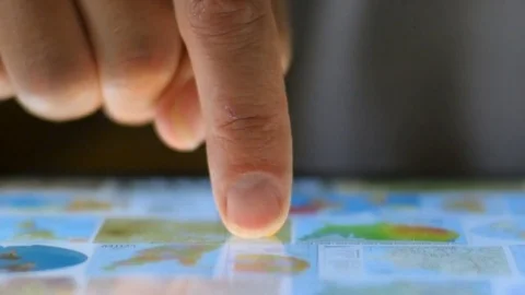 Extreme close up of a finger navigating a digital tablet selecting a map Video stock 78448832