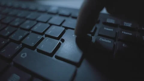 Extreme close up on finger pressing on enter or return key on computer keyboard Stockbeeldmateriaal 331216059