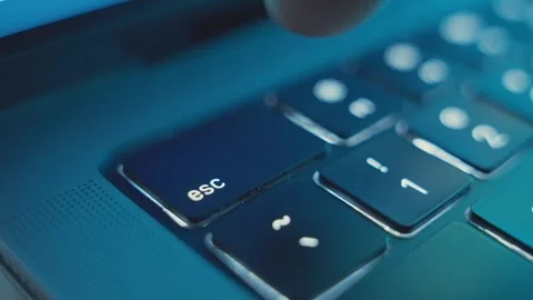 Extreme close up on finger pressing on Escape or Esc key on laptop keyboard Stock Footage 340234063
