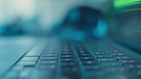 Extreme close up on finger pressing keyboard key at night in dark office Stock Footage 340234056