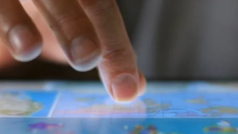 Extreme close up of finger on touchscreen digital tablet scrolling through maps Stock Footage 78448161