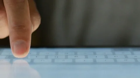 Extreme close up of finger typing on touchscreen keyboard tablet Stock Footage 78448093