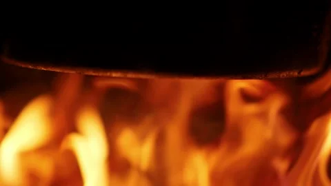 Extreme Close Up Fire Flames Blowing Around Camping Cooking Pot Видео 170610574