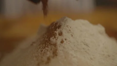 Extreme close-up of flour pile dusted with cinnamon Stock Footage 336374787