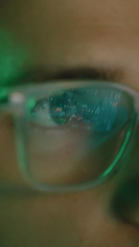 Extreme close-up of glasses reflecting screen with data, code, and information Stock Footage 344163524