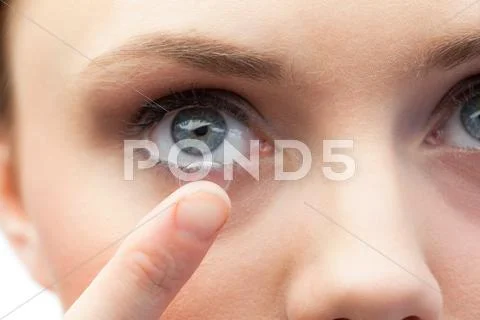 Extreme close up on gorgeous model applying contact lens Stock Photos