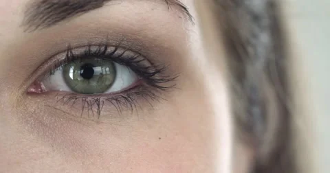 Extreme close-up of a green eye of a girl Stock Footage