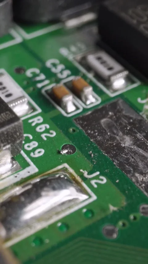Extreme close-up of green Printed Circuit Board Electronics shot with dolly Stock Footage 287492223