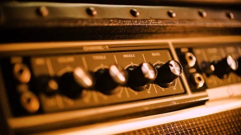 Extreme Close Up of Guitar amp control knobs basking in warm light. 動画素材 102828156