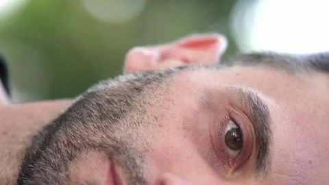 Extreme close-up of half face of young man in his 40s Stock Footage 275104693