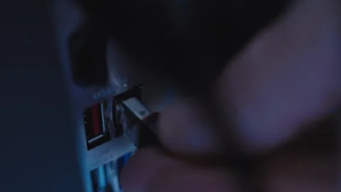 Extreme close up hand inserting thumb drive into desktop computer or server Stock Footage 335475216