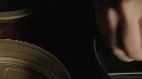 Extreme close up of hand loading 35mm film inside an old film camera magazine Stock Footage 127245944