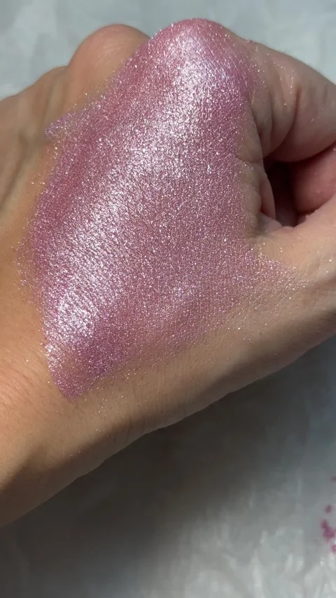 Extreme Close-Up of Hand Spreading High-Shine Pink Glitter Cosmetic Stock Footage 321866359