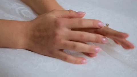 Extreme close up hands of the bride on white dress. Stock Footage 78961393