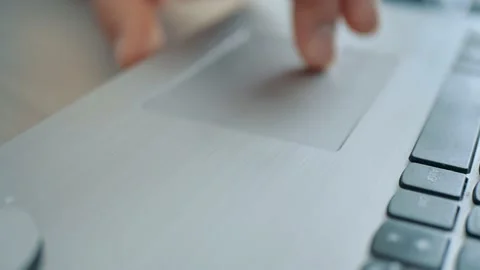 Extreme close-up of hands swiping in different directions on laptop touchpad in Stock Footage 216964986
