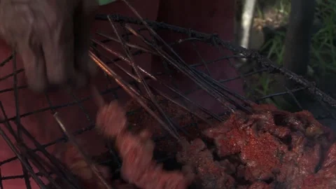 Extreme Close-Up of Hands Turning Meat on Grill in Badagry Nigeria Stock Footage 345932141