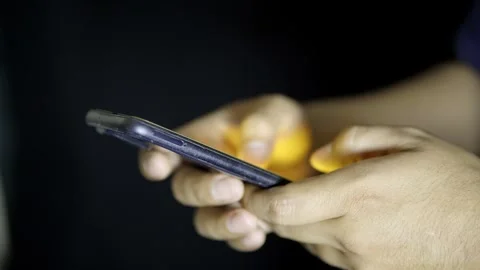 Extreme close up of hands using a cell phone at night Stock Footage 272255003