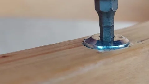 Extreme close-up of a hex screwdriver bit inserting into a metal screw head. Stock Footage 335834119