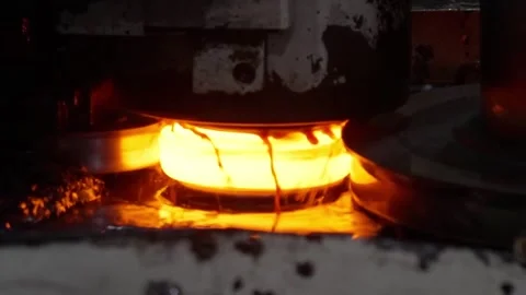 Extreme close-up of a hot ring rolling process where a glowing steel component Stock Footage 332918168