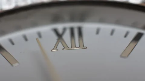 Extreme close-up of the hour hand passing over the 12 o'clock position. Stock Footage 231350442
