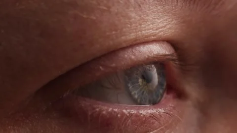 Extreme close-up of a human eye with blue iris and detailed skin texture Stock Footage 339212778