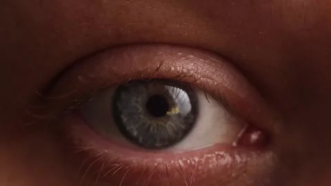 Extreme close-up of a human eye with blue-green iris and visible skin texture Stock Footage 339212848