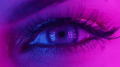 Extreme close up of human eye iris under neon light 4K. Female with beautiful Stock Footage 131880001