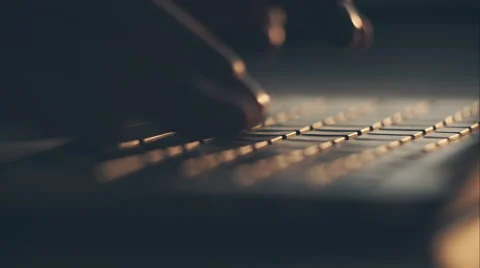 Extreme close-up of human hands on keyboard at sunset. RAW video record Stock Footage 61965439