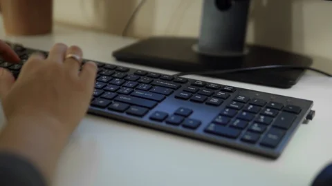 Extreme close-up of human hands on keyboard at sunset. 4k Stock Footage 116347354