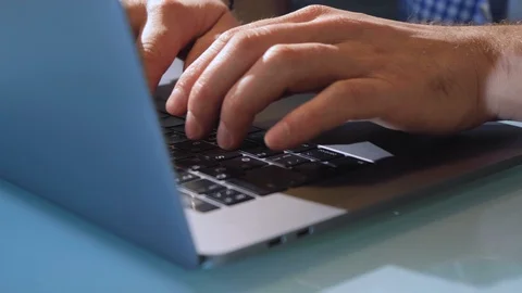 Extreme close-up human hands on keyboard. Hands type on laptop keyboard Stock Footage 128591472
