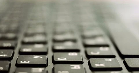 Extreme close-up of human hands typing on laptop keyboard with latin and Stock Footage 68928777