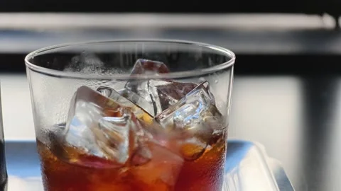 Extreme close-up of iced cold brew coffee in clear glass with ice cubes Stock Footage 344746811