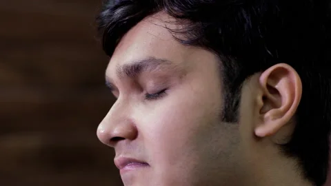Extreme close up of an Indian guy showing the expressions of disappointment Stock Footage 133300907