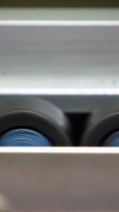 Extreme Close Up Of Industrial Roller Wheels Spinning Fast on Conveyor - 4K   Stock Footage 338040736