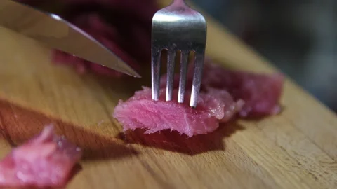 Extreme Close-up of Knife Blade Cutting Raw Tuna Female chef hand using fish Stock Footage 302674093