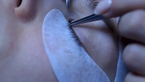 Extreme Close up. Lashes extentions procedure on white woman. Beginning Stock Footage 150599501