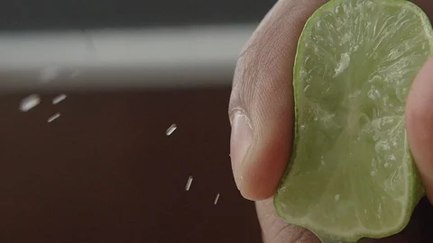 EXTREME CLOSE UP LEMON BEING SQUEEZE Stock Footage 107301892