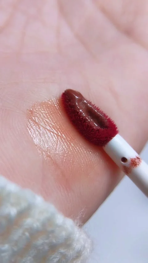 Extreme close up of lip tint brush being applied onto skin. Beauty content .. Stock Footage 340891142