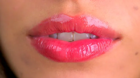 Extreme close up of lips blowing a kiss and smiling Stock Footage