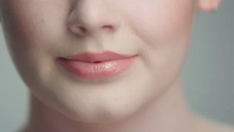 Extreme close up lips as confident model rotates towards camera slow motion 4K Video stock 193973031